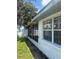 View of a screened in porch and exterior of home at 5025 Tammy Ln, Holiday, FL 34690