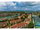 Aerial view of waterfront property, showcasing lush landscaping and community amenities at 505 Sandy Hook Rd # 505, Treasure Island, FL 33706