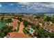 Picturesque aerial view highlighting the community's proximity to a pool, golf course, marina, and waterfront at 505 Sandy Hook Rd # 505, Treasure Island, FL 33706