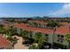 Aerial view of townhouses with a brick driveway, and water views in the distance at 505 Sandy Hook Rd # 505, Treasure Island, FL 33706