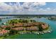 Beautiful waterfront condos with private boat slips on a sunny day with golf course and city views in the background at 505 Sandy Hook Rd # 505, Treasure Island, FL 33706
