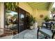 A covered outdoor balcony with comfortable seating overlooking the lush landscaping and tropical scenery at 505 Sandy Hook Rd # 505, Treasure Island, FL 33706