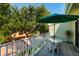Outdoor balcony with views of mature trees, and a table and chairs at 505 Sandy Hook Rd # 505, Treasure Island, FL 33706