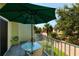 Balcony with table and chairs overlooking a charming neighborhood, perfect for relaxing outdoors at 505 Sandy Hook Rd # 505, Treasure Island, FL 33706