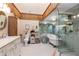 Bright bathroom with a claw foot tub and glass shower, complemented by wood accents at 505 Sandy Hook Rd # 505, Treasure Island, FL 33706