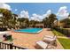 Resort-style community pool with lounge chairs surrounded by lush tropical landscaping on a sunny day at 505 Sandy Hook Rd # 505, Treasure Island, FL 33706