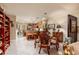Bright dining area featuring tile flooring, wicker dining set, and views of the kitchen and living spaces at 505 Sandy Hook Rd # 505, Treasure Island, FL 33706