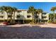 Charming townhouse complex featuring lush palm trees and a brick paved parking area at 505 Sandy Hook Rd # 505, Treasure Island, FL 33706