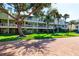Beautiful condo complex with lush landscaping, mature trees, and community sidewalk at 505 Sandy Hook Rd # 505, Treasure Island, FL 33706
