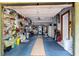 Spacious two-car garage featuring ample shelving and a laundry area at 505 Sandy Hook Rd # 505, Treasure Island, FL 33706