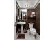 Charming half bath showcasing elegant fixtures, decorative wallpaper, and a unique chandelier at 505 Sandy Hook Rd # 505, Treasure Island, FL 33706