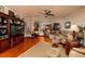 Spacious living room features hardwood floors, a large entertainment center, and an open floor plan at 505 Sandy Hook Rd # 505, Treasure Island, FL 33706