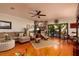 Inviting living room with hardwood floors, a stone fireplace, and sliding glass doors to the outdoors at 505 Sandy Hook Rd # 505, Treasure Island, FL 33706