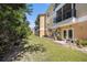 The backyard features a well-maintained lawn, a patio with outdoor seating, and lush greenery at 5065 Royal Palms Way # 303, New Port Richey, FL 34652