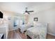 Bright bedroom features two twin beds with stylish ocean-themed bedspreads, ceiling fan, and a window for natural light at 5065 Royal Palms Way # 303, New Port Richey, FL 34652