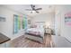 Bright bedroom with coastal decor, ceiling fan, and wood-look floors at 5065 Royal Palms Way # 303, New Port Richey, FL 34652