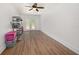 This bonus room features wood-look flooring, a ceiling fan, and ample space for storage and organization at 5065 Royal Palms Way # 303, New Port Richey, FL 34652