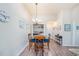 Dining area with wood table, chandelier, and hardwood floors near a utility closet at 5065 Royal Palms Way # 303, New Port Richey, FL 34652