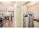 View of the hallway with a water heater closet and an open kitchen area at 5065 Royal Palms Way # 303, New Port Richey, FL 34652