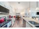 A kitchen featuring granite countertops, wooden floors, and white cabinets at 5065 Royal Palms Way # 303, New Port Richey, FL 34652