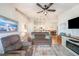 Open-concept living room with hardwood floors and ceiling fan leading to dining room at 5065 Royal Palms Way # 303, New Port Richey, FL 34652
