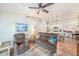 Cozy living room with hardwood floors, ceiling fan, and open view to the kitchen at 5065 Royal Palms Way # 303, New Port Richey, FL 34652