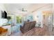 Bright living room with wood floors, ceiling fan, and sliding glass doors to a balcony at 5065 Royal Palms Way # 303, New Port Richey, FL 34652