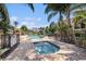 Community pool area featuring a swimming pool, hot tub, lounge chairs, and well-maintained landscaping at 5065 Royal Palms Way # 303, New Port Richey, FL 34652