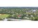 Community aerial view showcasing an athletic field, lush greenery, and a nearby body of water at 5090 White Pine Ne Cir, St Petersburg, FL 33702