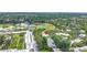 Scenic aerial view highlighting a verdant community, athletic fields, and lush tree coverage at 5090 White Pine Ne Cir, St Petersburg, FL 33702
