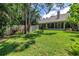 Expansive backyard featuring verdant lawn and view of the home's screened lanai at 5090 White Pine Ne Cir, St Petersburg, FL 33702