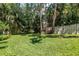 Spacious backyard with lush green grass and mature trees at 5090 White Pine Ne Cir, St Petersburg, FL 33702