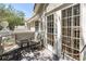 Outdoor seating on a balcony with white railings and French doors; a perfect spot to enjoy neighborhood views at 5090 White Pine Ne Cir, St Petersburg, FL 33702