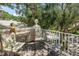 A charming balcony featuring comfortable seating and a view of the lush neighborhood, perfect for relaxation and enjoying the outdoors at 5090 White Pine Ne Cir, St Petersburg, FL 33702