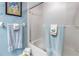 Bathroom with glass shower door, light blue walls and playful decor for a cheerful and clean space at 5090 White Pine Ne Cir, St Petersburg, FL 33702