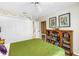 Bright bedroom featuring a cozy bed, ceiling fan, and a stylish wooden bookshelf with unique decorations at 5090 White Pine Ne Cir, St Petersburg, FL 33702