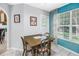 Charming breakfast nook with wooden table, chairs, and window with blue tiled wall at 5090 White Pine Ne Cir, St Petersburg, FL 33702