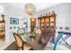 Cozy dining space with decorative cabinet, modern chandelier, and chairs with interesting accents at 5090 White Pine Ne Cir, St Petersburg, FL 33702