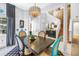 Bright dining area featuring a modern chandelier, sleek wood table, and unique blue accented chairs at 5090 White Pine Ne Cir, St Petersburg, FL 33702