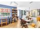 Spacious office with ample shelving, a ceiling fan, and plenty of natural light from stained glass window at 5090 White Pine Ne Cir, St Petersburg, FL 33702