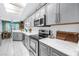 Kitchen boasts gray cabinets, white marble countertops, modern appliances, and adjacent breakfast nook at 5090 White Pine Ne Cir, St Petersburg, FL 33702