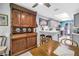 Eat-in kitchen features a large antique hutch with adjacent kitchen with gray cabinets at 5090 White Pine Ne Cir, St Petersburg, FL 33702