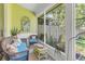 Comfortable wicker seating in screened lanai overlooking lush greenery at 5090 White Pine Ne Cir, St Petersburg, FL 33702