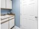 Functional laundry area with a utility sink, ample storage, and a clean, well-maintained appearance at 5090 White Pine Ne Cir, St Petersburg, FL 33702