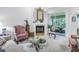 Bright living room featuring a fireplace, comfortable seating, and sliding glass doors at 5090 White Pine Ne Cir, St Petersburg, FL 33702
