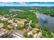 Aerial view of lakefront community with manicured lawns and lush landscaping, plus community pool at 5103 Puritan Cir # 5103, Tampa, FL 33617