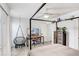 Bright bedroom featuring modern canopy bed, a desk, and a trendy swing chair at 5103 Puritan Cir # 5103, Tampa, FL 33617