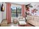 This Bedroom is decorated with a botanical wall print and features a rocking chair, and a crib at 5103 Puritan Cir # 5103, Tampa, FL 33617