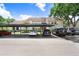 Exterior view of condo building with covered parking area and various parked cars on a bright sunny day at 5103 Puritan Cir # 5103, Tampa, FL 33617