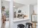 Kitchen features white cabinetry, stainless appliances, white subway tile backsplash, and a breakfast bar at 5103 Puritan Cir # 5103, Tampa, FL 33617